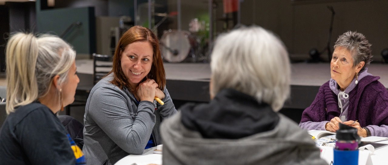 People in a classroom taking notes and learning